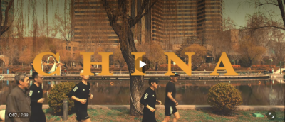 Group of men running with CHINA written in golden lettering across screen